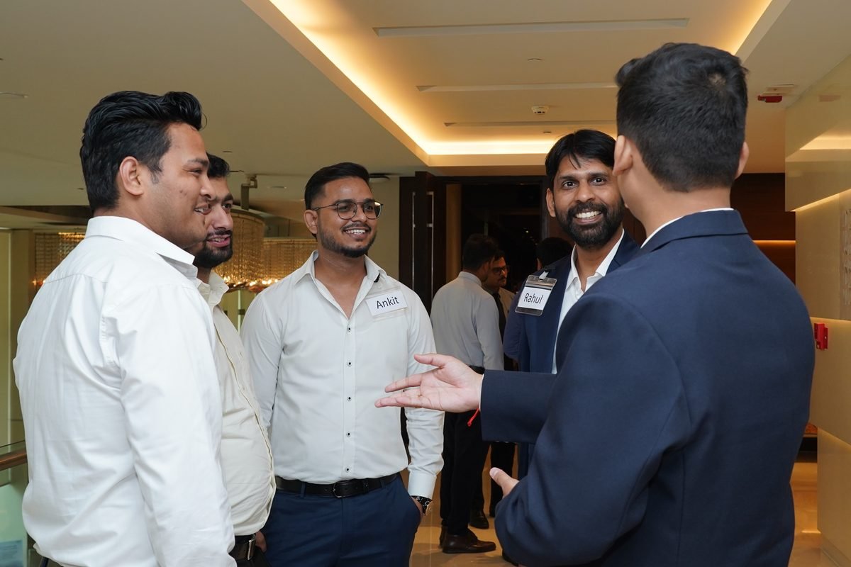 Four participants talking in the hotel corridor between sessions